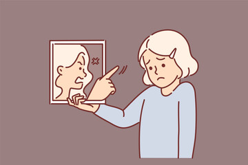 Sad little girl holding mirror with swearing reflection, for concept of low self-esteem