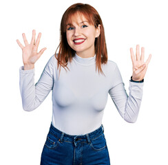Redhead young woman wearing casual turtleneck sweater showing and pointing up with fingers number...