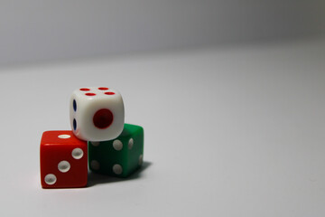 Close up of three different colored dice red, green, and white isolated on white background