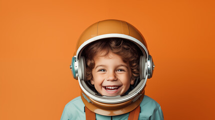 Smiling boy in space suit wearing helmet and smiling at camera, Astronaut futuristic kid boy, minimalist orange background, generative ai  - obrazy, fototapety, plakaty