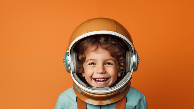 Smiling boy in space suit wearing helmet and smiling at camera, Astronaut futuristic kid boy, minimalist orange background, generative ai 