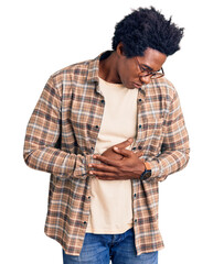 Handsome african american man with afro hair wearing casual clothes and glasses with hand on...