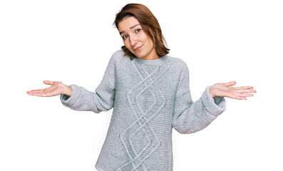 Young caucasian girl wearing casual clothes clueless and confused expression with arms and hands...