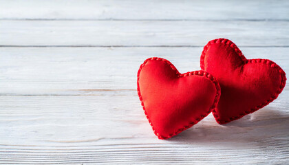 Valentines day background with two red hearts on white wooden table