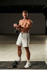 With each repetition, the athletic man on the gym mat epitomizes discipline and determination in...