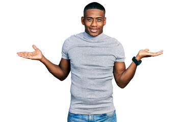 Young black man wearing casual t shirt smiling showing both hands open palms, presenting and...
