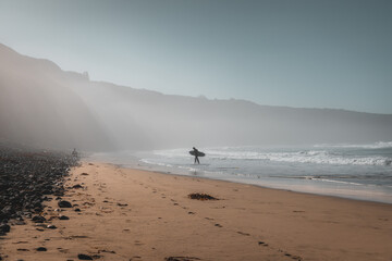Surfer on Beach with Light Beams - 710023685