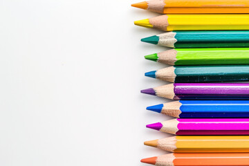 Fototapeta premium colourful pencils on white background, copy space 