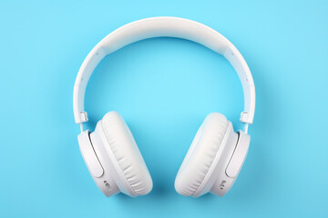 White headphones on a bright pastel background