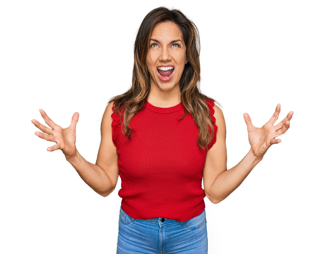 Young hispanic woman wearing casual clothes crazy and mad shouting and yelling with aggressive expression and arms raised. frustration concept.
