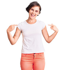 Beautiful young woman with short hair wearing casual clothes looking confident with smile on face, pointing oneself with fingers proud and happy.