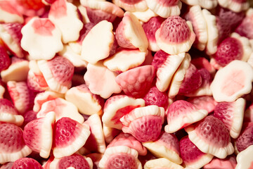 Background of pink and white chewy gelatin sweets, close-up.