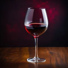 Fotobehang Glass with red wine on a dark background © Svetlana Zibrova