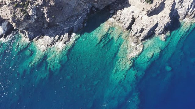 Drone footage of Mediterranean Sea along the rocky, blue coast. Elba, Italy