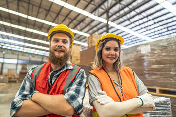 Team workers carpenter wearing safety uniform and hard hat working and checking the quality of wooden products at workshop manufacturing. man and woman workers wood in dark warehouse industry.