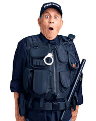 Senior handsome man wearing police uniform scared and amazed with open mouth for surprise,...