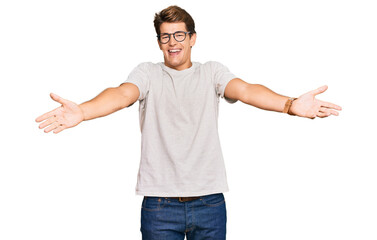 Handsome caucasian man wearing casual clothes and glasses smiling cheerful offering hands giving assistance and acceptance.