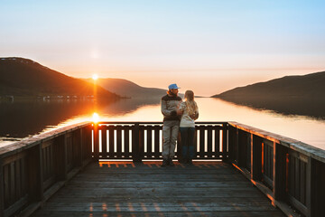 Couple in love on Valentines day  together family travel lifestyle romantic dating relationship man and woman walking on pier enjoying sunset view outdoor lake and mountains landscape