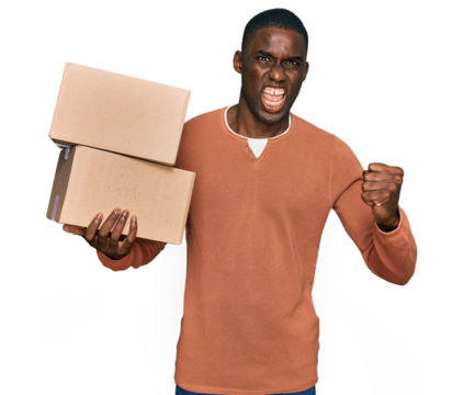 Young african american man holding delivery package annoyed and frustrated shouting with anger, yelling crazy with anger and hand raised