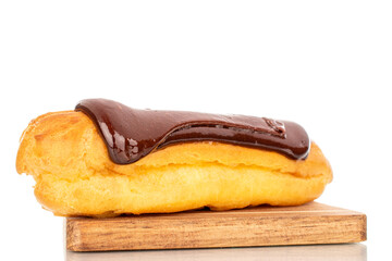 One delicious chocolate eclair, close-up isolated on white.
