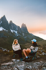 Couple man and woman on camping trip traveling together Valentines day friends hiking outdoor in mountains family lifestyle relationship sitting on chairs, romantic relationship wife and husband - obrazy, fototapety, plakaty