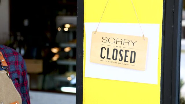 Small Business Crisis Waitress Worker Or Cafe Owner Decides To Closing Down Coffee Shop Hold Closed Hanging Sign Board In Front Of The Restaurant, Lost Investment Poor Knowledge For Business Start-up