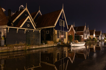 Row of houses in the evening by the water in the picturesque village of De Rijp in the Netherlands,...