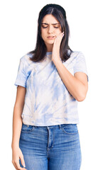 Young beautiful girl wearing casual t shirt touching mouth with hand with painful expression because of toothache or dental illness on teeth. dentist