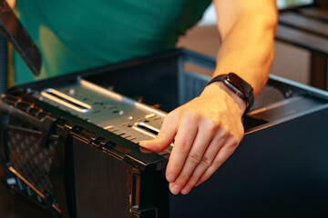 Male hands repairing computer hardware close up