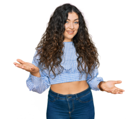 Young hispanic girl wearing casual clothes smiling cheerful with open arms as friendly welcome, positive and confident greetings