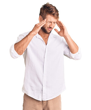 Young caucasian man wearing casual clothes with hand on head for pain in head because stress. suffering migraine.
