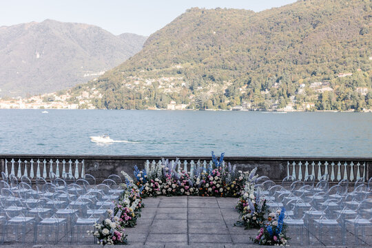Wedding ceremony in Como lake. Very beautiful and stylish wedding arch, decorated with various fresh flowers, standing in the garden. Wedding day. Fresh flowers decorations, Peony weddng.