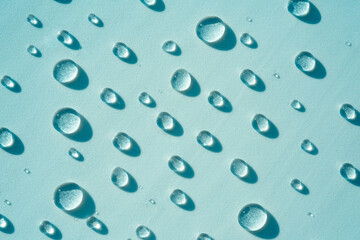 Blue drops of pure liquid, transparent water background. Concept of moisturizing cosmetics, spa...