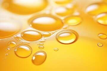 Golden yellow oil bubbles macro photography on white background.