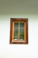 One old window with wooden frame, a fragment of the facade of an old building in Tatra Mountains, Poland. 