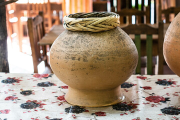 Traditional clay jug at a restaurant in Oaxaca, Mexico. Traditional clay jug used for drink coffee, chocolate and atole in Oaxaca, Mexico