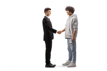 Full length profile shot of a young casual man shaking hands with a young professional man
