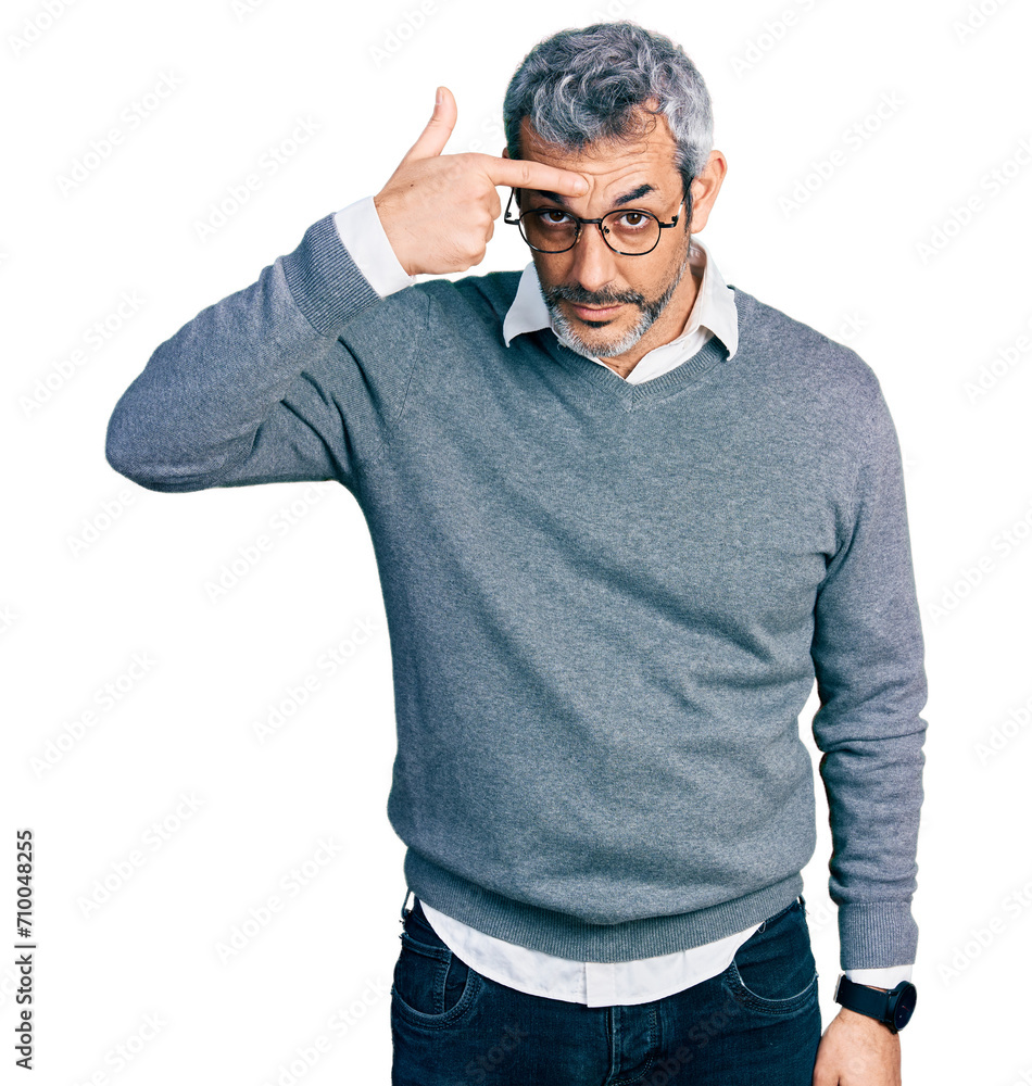 Sticker middle age hispanic with grey hair wearing glasses pointing unhappy to pimple on forehead, ugly infe