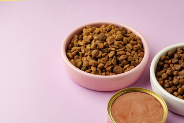 Cat food on pink background in studio