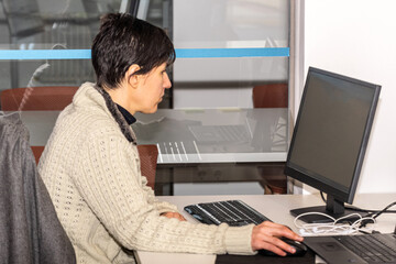A woman working in office in front of computer