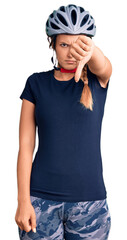 Beautiful caucasian woman wearing bike helmet looking unhappy and angry showing rejection and negative with thumbs down gesture. bad expression.