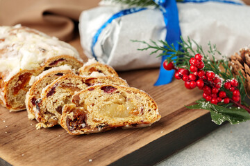 Christmas stollen on wooden cutting board close up