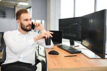 Financial Analysts and Day Traders Working on a Computers with Multi-Monitor Workstations with Real-Time Stocks, Commodities and Exchange Market Charts