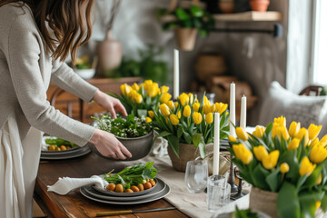 Woman arranging yellow tulips at easter dining table