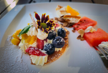 Dessert with whipped cream and fruits such as blueberry, strawberry and watermelon etc.