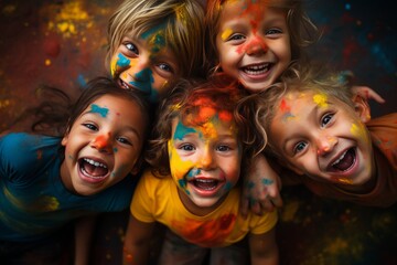 Obraz premium A little boy and girl with paint all over his face. Beautiful girl and boy play with colored smoke. They look at the camera. Summer games.