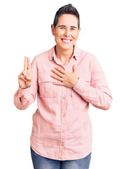 Young woman with short hair wearing casual clothes smiling swearing with hand on chest and fingers...