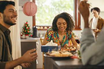 Happy friends enjoying in conversation during festive dinner at home party