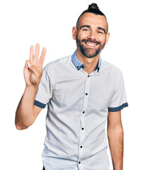 Hispanic man with ponytail wearing casual white shirt showing and pointing up with fingers number three while smiling confident and happy.