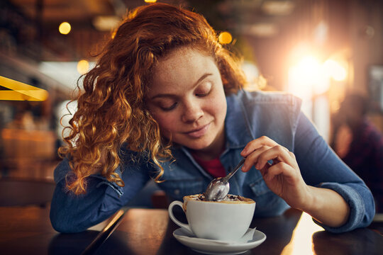 Happy woman eating dessert in a cafe